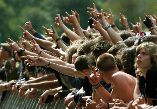 Fans cheer for German rock band Skyline as the opening act. The festival has been growing in the small town of Wacken since 1990 to become the biggest of its kind.Photo: DPA