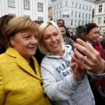 'Bring home the bacon,' Merkel tells voters on eve of poll