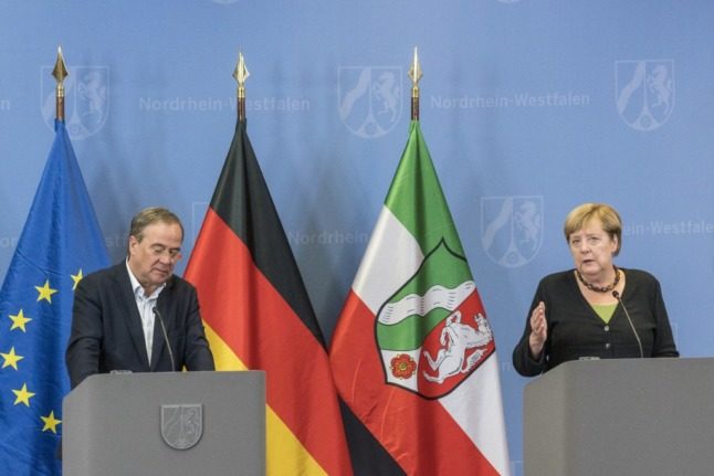 Merkel defends would-be successor on German flood zone tour