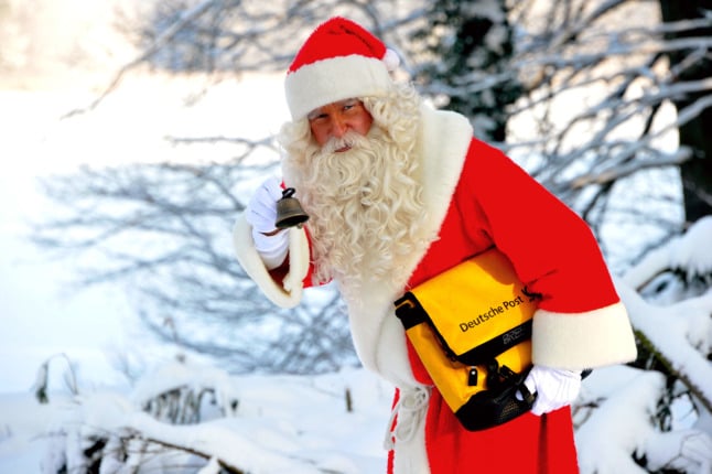 A man dressed as Santa delivers post