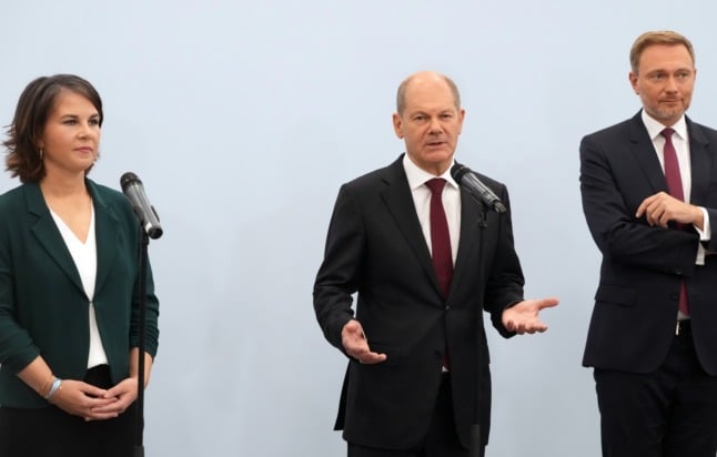 The Greens' Annalena Baerbock, the SPD's Olaf Scholz and the FDP's Christian Lindner talk to the press on Friday. 