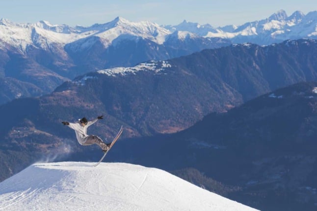 A skier pulling off a funky trick in the Swiss ski field of Laax