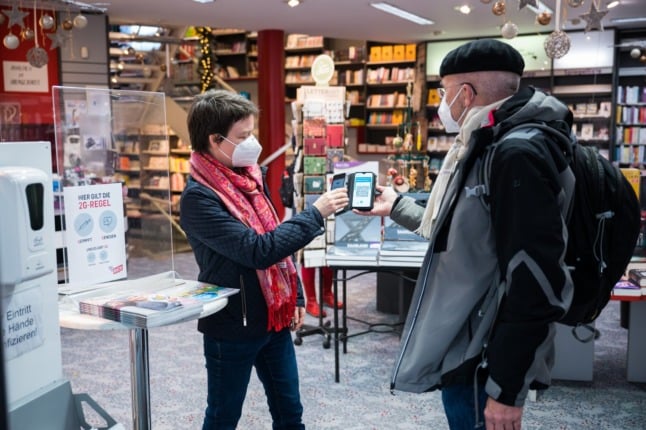 A customer showing the EU digital vaccine pass at a book store in Saarbrücken.