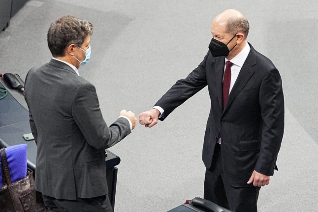 New German Chancellor Olaf Scholz fist bumps the Greens' Robert Habeck.