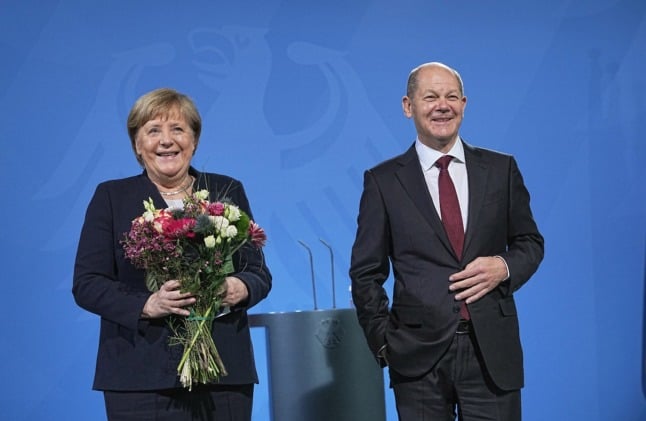 Angela Merkel receives flowers from new German Chancellor Olaf Scholz