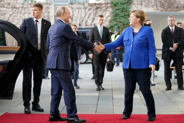 Russian President Vladimir Putin and former German Chancellor Angela Merkel in Berlin in January 2020.