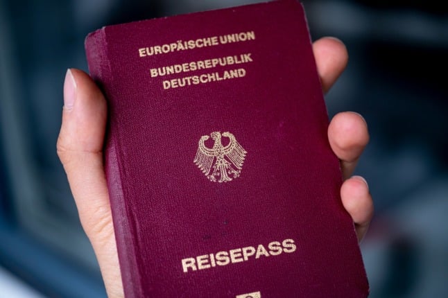 A person holds a German passport. 